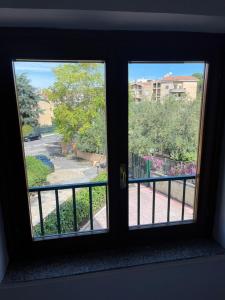 a window in a room with a view of a street at Castelli Home - Castelli Apartments in Albano Laziale