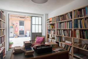 a room filled with book shelves filled with books at YouHosty - Metauro 4 in Milan
