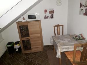 a dining room with a table and a microwave at Gästehaus Natterer - FeWo 2 in Momlingen +7 photos
