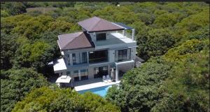 an aerial view of a house in the forest at Mangolia Farm in San Juan