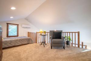 a bedroom with a bed and a chair at The Goldfinch Cabin 15 MIN to Magnolia Baylor in Elm Mott