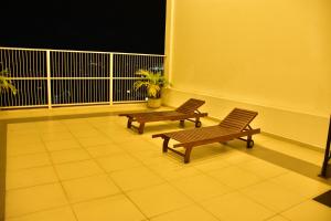 two benches sitting on top of a balcony at BNB RESIDENCIES NAWALA in Nawala