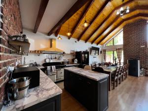 a large kitchen with a counter and a dining room at Paradise Resort in Miercurea-Ciuc