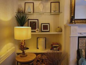 a lamp sitting on a table in a room at MacLeen Cottage in Arrochar