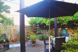 a blue umbrella in a patio with a table and chairs at Kamoro in Trier