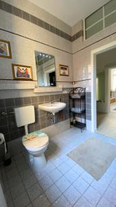 a bathroom with a toilet and a sink at Kamoro in Trier