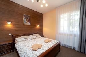 a bedroom with a bed with two towels on it at Penzion Josu in Zuberec