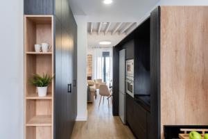 korytarz z drzwiami prowadzącymi do salonu w obiekcie One&lux Puerta Osario w Sewilli