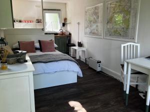 a bedroom with a bed and a desk in it at Lynbrook Cabin and Hot Tub, New Forest in Ringwood