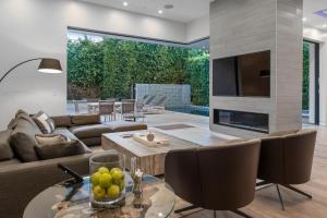 a living room with a couch and a fireplace at Orlando Estate in Los Angeles