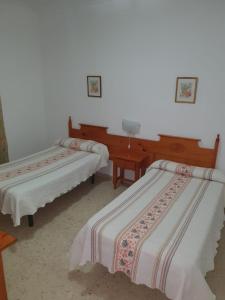 拉普埃夫拉德卡薩利亞的住宿－Pensión los Ángeles，配有两张床的客房内。