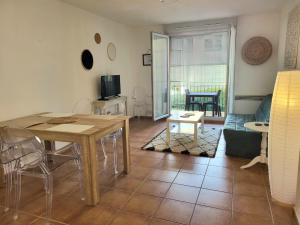 a living room with a table and a couch at Le Pietra in Uzès