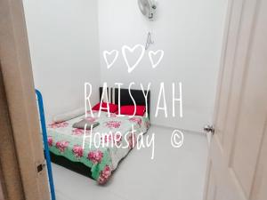a bedroom with a bed with a home sly sign at Raisyah Homestay, Melaka in Malacca