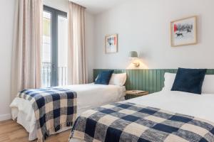 Ένα ή περισσότερα κρεβάτια σε δωμάτιο στο Magno Apartments Cabo Noval Luxury House