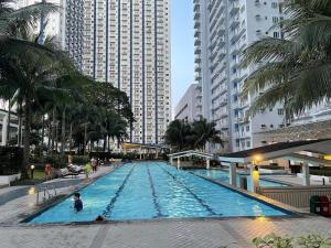 a large swimming pool in a city with tall buildings at relaxing city view in Manila