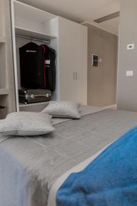 a bedroom with a bed with a tv on the wall at EUROPA Hotel in Vasto
