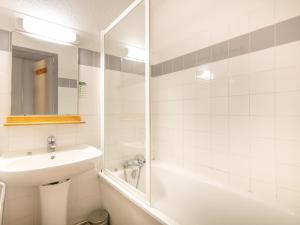a bathroom with a sink and a tub and a shower at Vacancéole - Le Dôme des Rousses in Vaujany