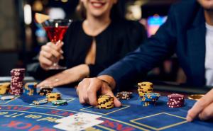 a man and a woman playing poker at a casino at Hotel Paris in Opatija