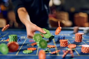a person is playing poker on a blue table at Hotel Paris in Opatija