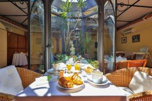 a table with croissants and croissants on it at Hôtel Playa in Saint-Tropez