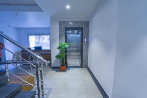 a hallway with a staircase and a plant at Hotel TrushaDham Near to Mahalaxmi Temple Kolhapur in Kolhapur