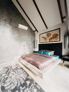 a bedroom with a large bed with a black headboard at Novella in Varkala
