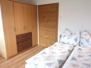 a bedroom with a bed and a closet at Apart MountainView in Bruck am Ziller