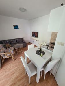 a living room with a white table and chairs at Apartments Lana - 30 m from the sea in Seline