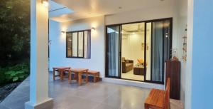 a dining room with a table and chairs in a house at Little Alley House in Cat Ba