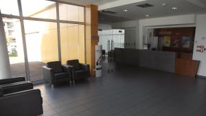 a waiting room with two chairs and a counter at HI Lousã – Pousada de Juventude in Lousã