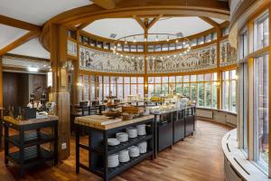 a large kitchen with a large ceiling with windows at Best Western Gustaf Wasa Hotel in Borlänge