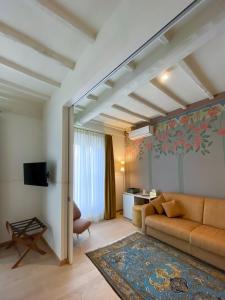 a living room with a couch and a living room with a table at PALAZZO ESSENZA in San Miniato