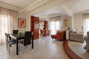 a dining room and living room with a table and chairs at Casa di Vasia in Gennadi