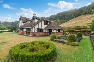a large house on a hill with a yard at skyline mountain view Lodge up to 16 people in Rotorua