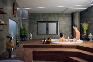 two people in a bath tub in a bathroom at Hotel Paris in Opatija