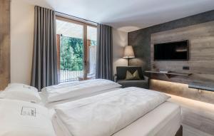 Postel nebo postele na pokoji v ubytování Hotel Christof