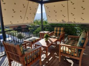 a patio with chairs and tables and umbrellas at Maria Papada's Traditional Village House in Kondóstavlos