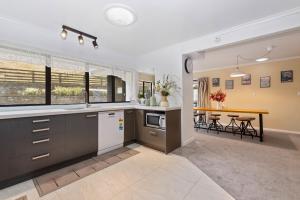 a kitchen with a sink and a table in a room at skyline mountain view Lodge up to 16 people in Rotorua +44 photos