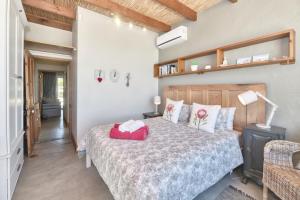 a bedroom with a bed with a wooden headboard at Colours of the Sea Apartment in Struisbaai