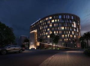 a car parked in front of a building at night at Hotel Royal ASBU Tunis in Tunis