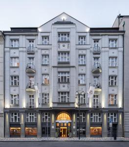 a large building with a large clock on the front of it at The Emblem Prague Hotel - Preferred Hotels & Resorts in Prague
