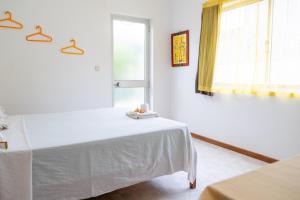 A bed or beds in a room at Simabo's Backpackers' Hostel