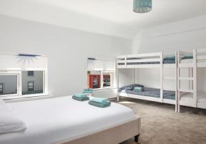 a bedroom with two beds and two bunk beds at urchin Loft in Ardmore