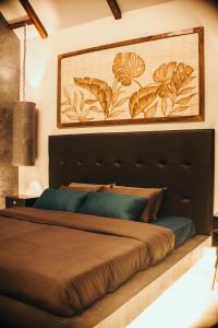 a large bed with a black headboard in a bedroom at Novella in Varkala