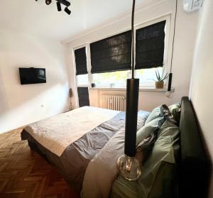 a bedroom with a bed and a window at Sofia Downtown Boutique Apartment in Sofia