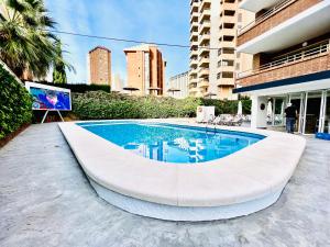 a swimming pool in the middle of a building at Trebol One Apartments By Mc in Benidorm