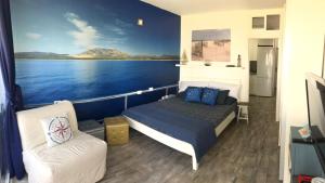 a bedroom on a boat with a bed and a couch at CasaBarco in Costa Del Silencio +39 photos