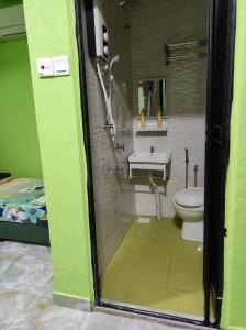 a bathroom with a toilet and a sink and a shower at CTZ PAROH RIVER PARK in Jertih