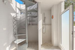 a spiral staircase in a bathroom with a shower at Villetta a Mare in Olbia +17 photos