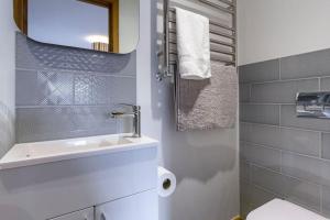 a bathroom with a sink and a mirror and a toilet at Number 15 - Bude Cornwall in Bude +93 photos
